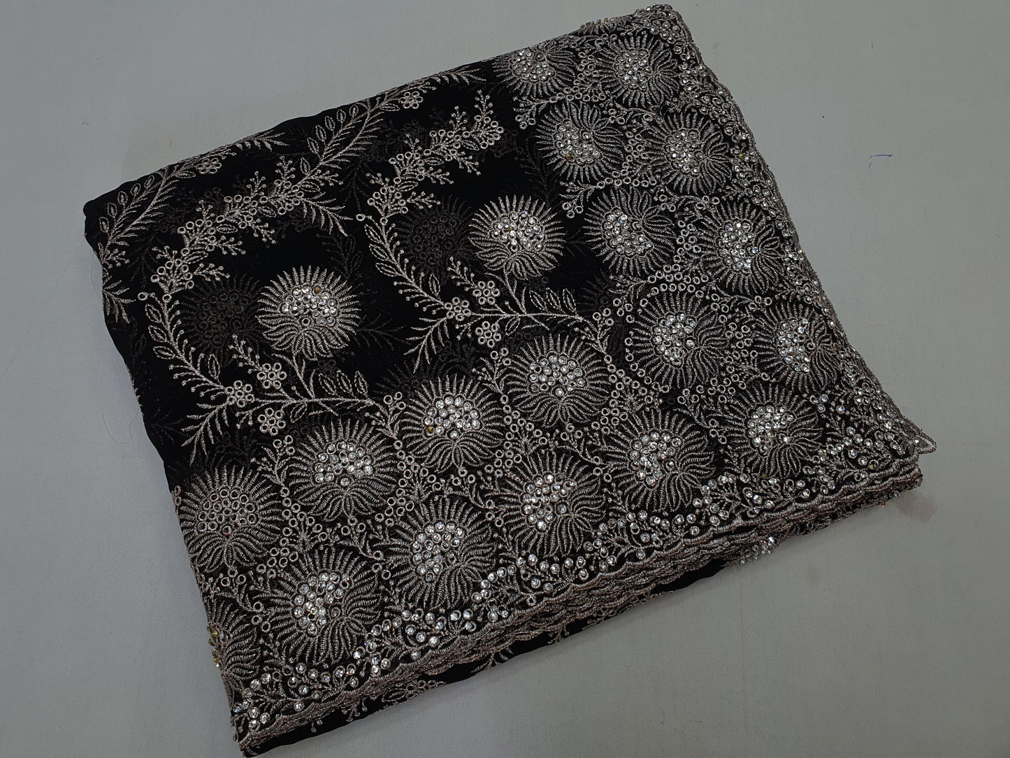 Allover silver jari jall with jarkan stone border on Georgtee 
Saree