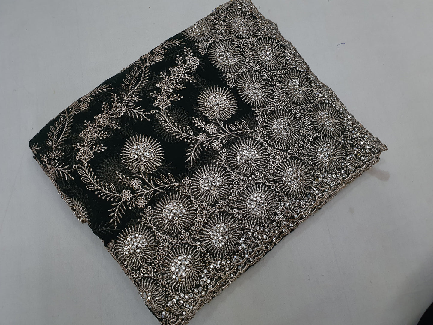 Allover silver jari jall with jarkan stone border on Georgtee 
Saree