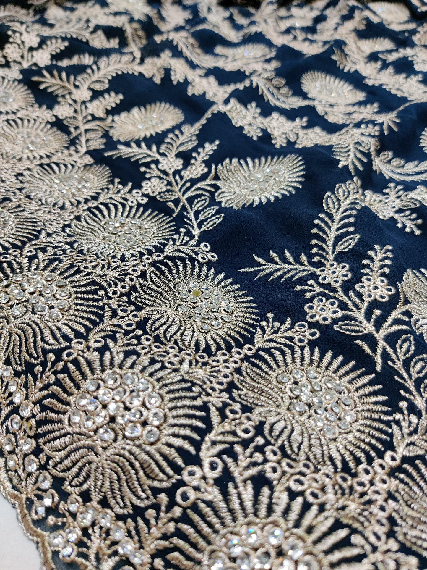 Allover silver jari jall with jarkan stone border on Georgtee 
Saree