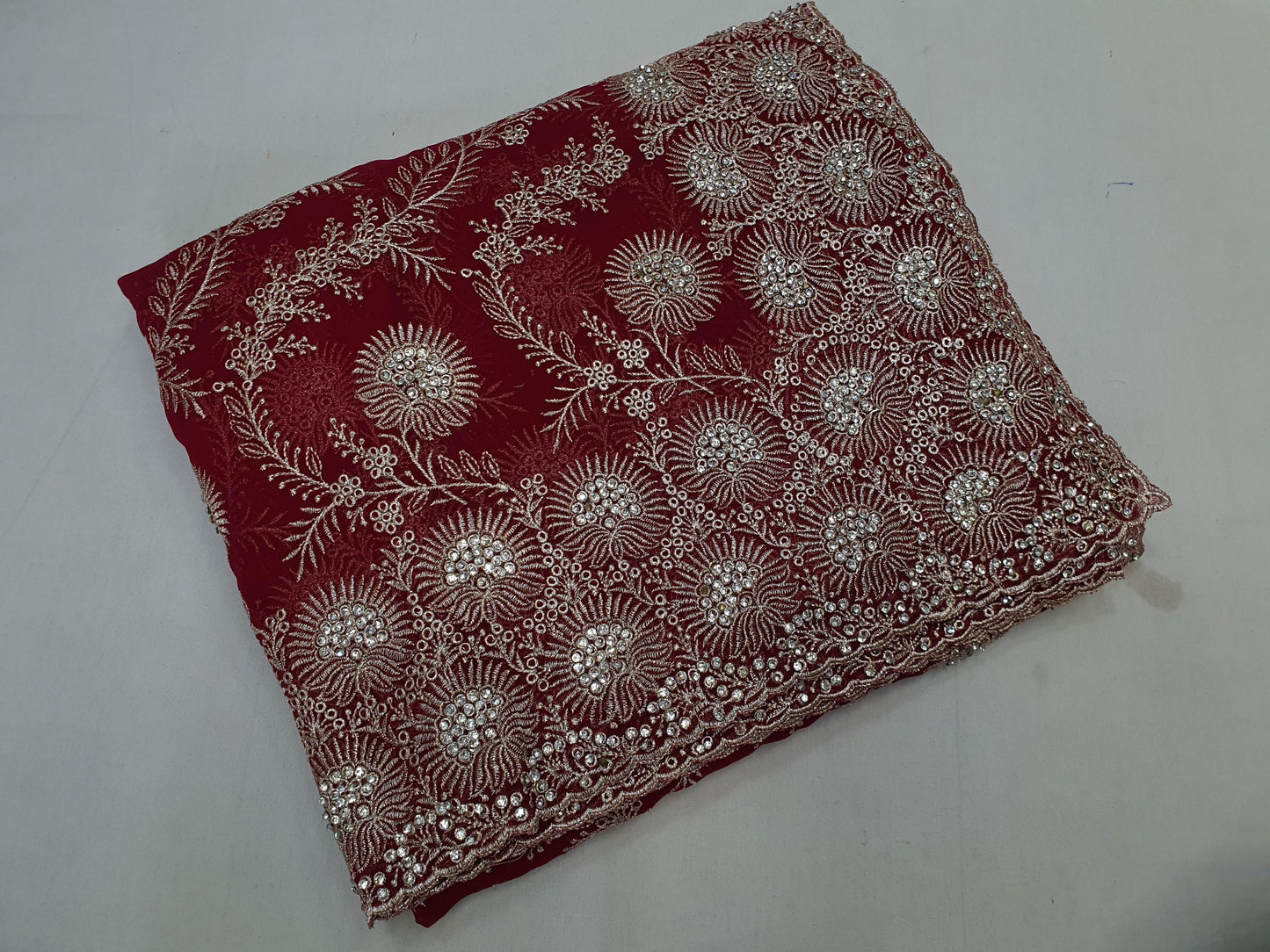 Allover silver jari jall with jarkan stone border on Georgtee 
Saree